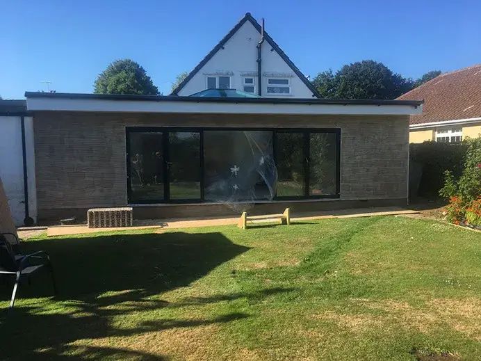 White render rear extension with full-height glazing onto the garden