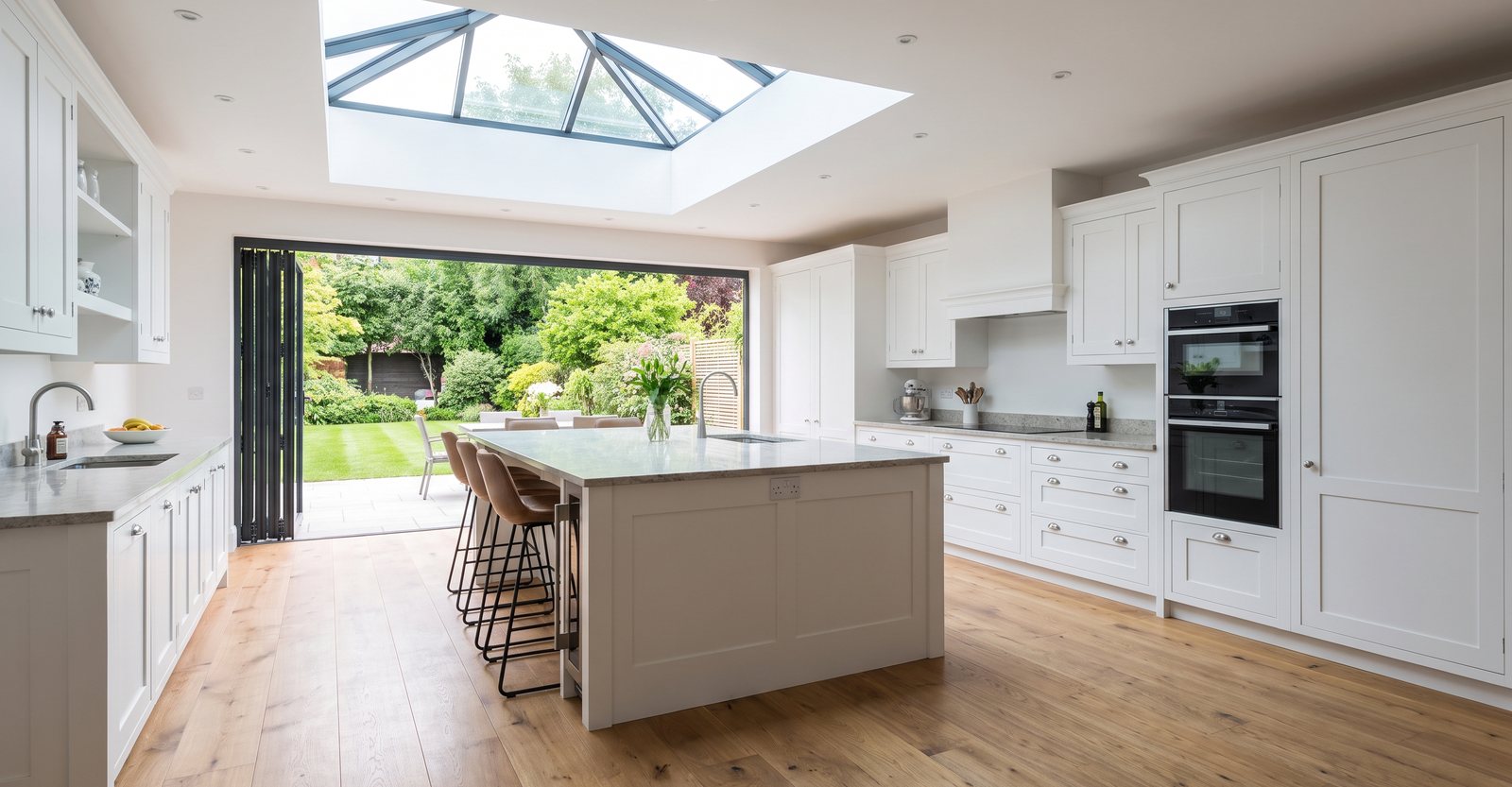 Extension mid-build with exposed roof timbers and scaffolding around the new structure