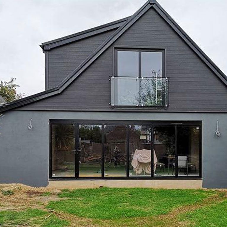 Dark clad house with a large glazed rear extension