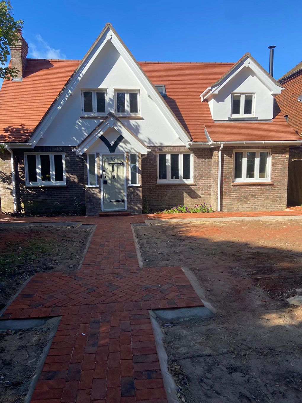 Block paved driveway running up to the front of a house