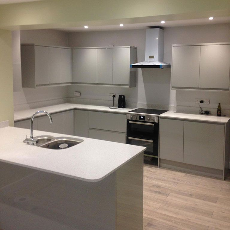 Grey handleless fitted kitchen installed as part of a property refurbishment