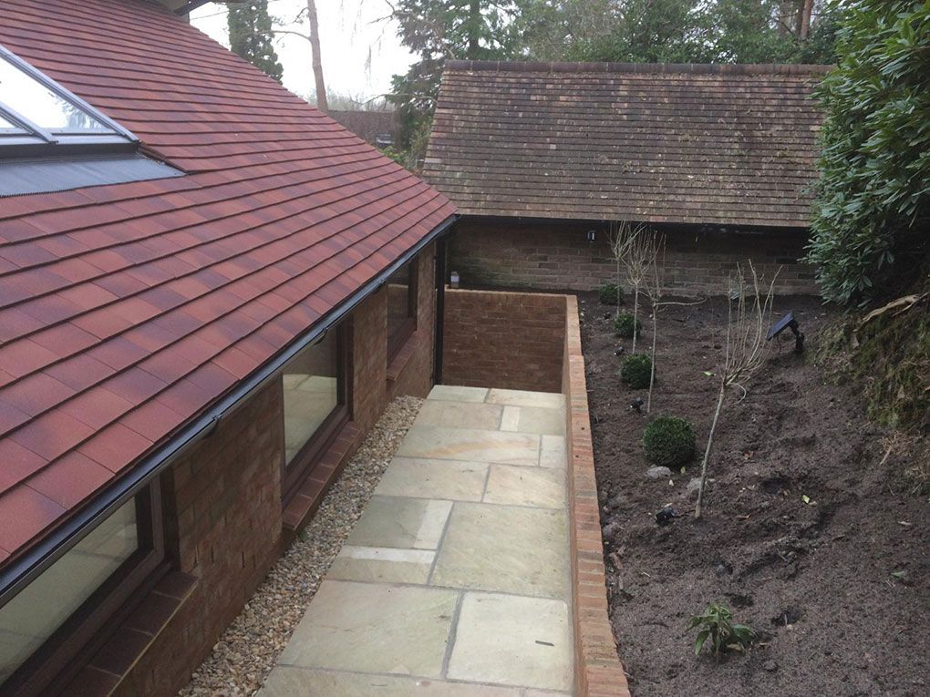 Indian sandstone patio with matching steps laid in a rear garden