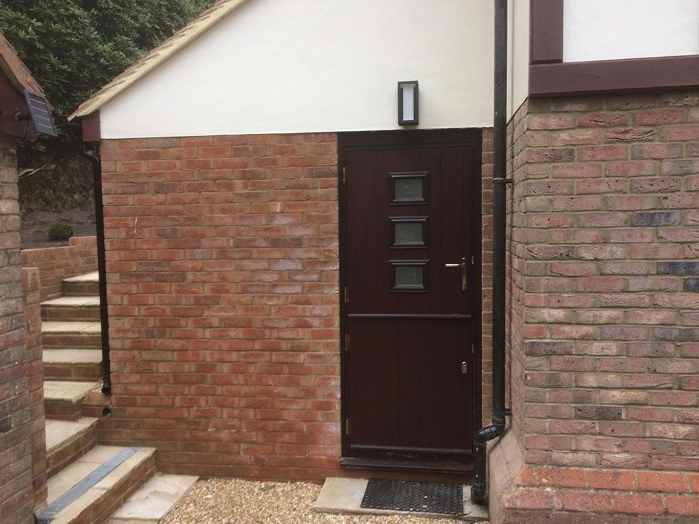 Brick porch with an anthracite composite front door, matching brickwork and mortar