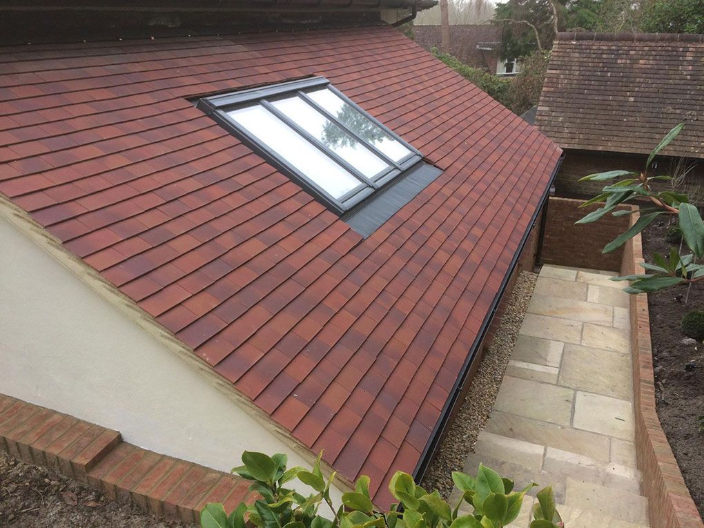 Loft room with a pitched ceiling and a large roof window